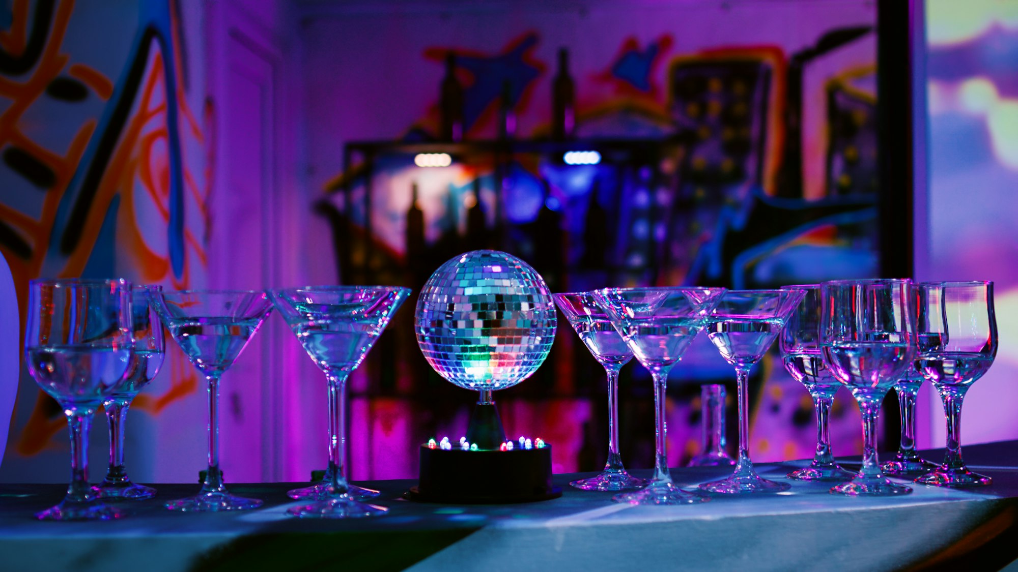 Empty bar with alcohol drinks in glasses